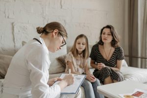 A Doctor in a Consultation with a Mother and Her Daughter